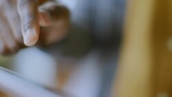 Young man clicks and types on touchscreen of tablet computer Stock Footage