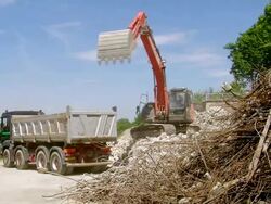 WS excavator loading material in dumper at deconstruction of bridge over river Mosel / Wellen, Rhineland Palatinate, Germany Stock Footage