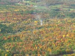 WS ARIEAL View of Smoke coming into wooded area and autumn color / Maine, United States Stock Footage
