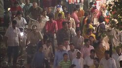 Throngs of people crowd the streets and patronize market stalls during a Diwali celebration. Stock Footage