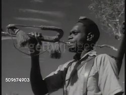 1941: FRENCH TERRITORIES: NEW CALEDONIA: Indigenous Melanesian men in Free French uniforms walking roadway. MS Indigenous Melanesian bugler, WS Men training running down, up hillside paths. Indigenous people's of Oceania, not 'Kanaks', Colonial Rule. Instructional Video