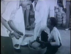 1950s B/W MS Man exchanging saw at black market / Vietnam Stock Footage