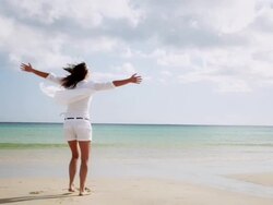 Woman spinning on beach Stock Footage
