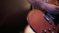 Guitarist adjusts amp, strums and tunes guitar on stage during sound check Stock Footage