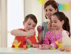 Mother and children painting easter eggs Stock Footage