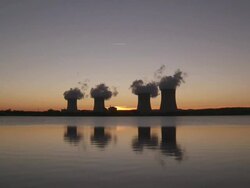 WS Cooling towers of power station at sunset and reflection in the water / Cattenom, Lorraine Mosel, FRANCE Stock Footage