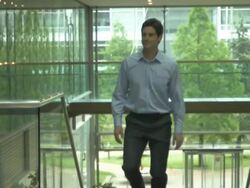 Business man and woman meet and shake hands; UK Stock Footage