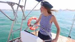 beautiful pirate at the helm of a yacht Stock Footage