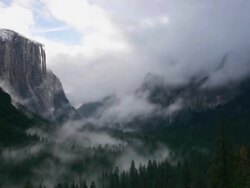 TL, Dramatic clearing winter storm clouds moving through valley, looking at El Capitan & Bridalveil Fall, Yosemite Valley in Yosemite National Park, California Stock Footage