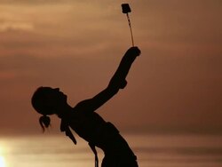 CU Sihouetted female poi dancer performs in front of fiery sunrise sky and ocean / Montezuma, Costa Rica Stock Footage