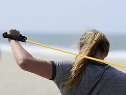ECU CU of female beach volleyball player stretching and using bands to warm up. Stock Footage