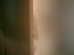 Young woman in underwear opening door Stock Footage