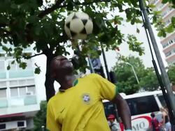 MS TU TD Shot of coloured guy with brazilian trikot playing freestyle football at street corner / Rio de Janeiro, Brazil  Stock Footage