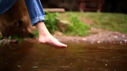 Bare feet of a woman. river water. Stock Footage