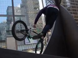 A young man riding his BMX bicycle and doing a trick. - Slow Motion - Model Released - HD Stock Footage