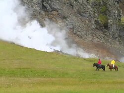 MS Shot of people on horseback walking at farm with hot springs / Porvaldseyri, Sudhurland, Iceland Stock Footage