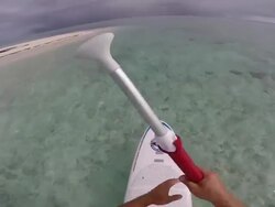 POV of a man stand-up paddle boarding in the lagoon around Bora Bora island in French Polynesia. - Slow Motion Stock Footage