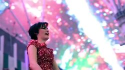 Young couple throw their hands in the air and spin under the bright lights of downtown Las Vegas Stock Footage