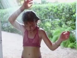 MS Shot of young girl taking outdoor shower / St. Simons Island, Georgia, United States Stock Footage
