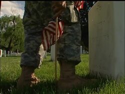 With Memorial Day weekend almost here, U.S. troops were placing American flags today in the vast fields of headstones at Arlington National Cemetery just outside Washington. News Clip