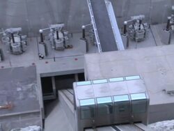 Multiple pan-left tilt-up - A car ascends the steep side of a dam / Grand Coulee Dam, Washington Stock Footage