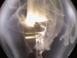ECU SLO MO Shot of light bulb, showing burning and smoking tungsten wire / Munich, Bavaria, Germany Stock Footage