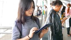 Woman use social media for communication in the sky train Stock Footage