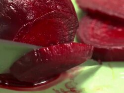  CU Beets on green plate being sliced with knife / Los Angeles, California, United States Stock Footage