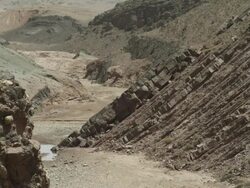 Fractured, textured rock stretchess out of the river bed below. Stock Footage
