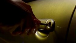 Man breaking into the car by manipulating the door lock Stock Footage