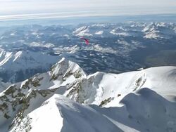 WS AERIAL TS paramotor turning towards the summit of the mont blanc / chamonix, Haut savoir, france  Stock Footage