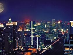 Moon over night city Stock Footage