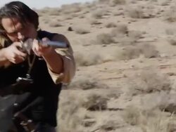 Cowboy turning and lifting rifle to shoot. Stock Footage