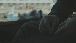 Fishermen at work cleaning and fixing fishing nets Stock Footage