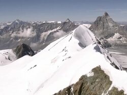 WS AERIAL View of mountaineers on ridge and Klein Matterhorn with Mont Blanc / Breithorn, Valais, Switzerland Stock Footage