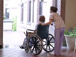 WS Nurse pushing senior woman in wheelchair / Washington State, USA Stock Footage