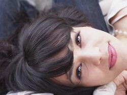 ECU Shot of beautiful brunette lays napping on park bench on lap of her guy and smiles / Portland, Oregon, United States  Stock Footage
