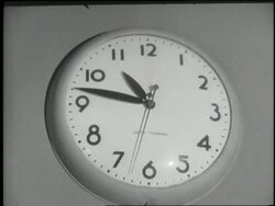 Seconds tick away on an electric wall clock. News Clip