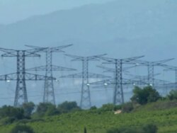 LOW AERIAL, Electricity pylons on field, France Stock Footage