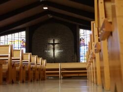 The interior of a church with classic church pews and the cross of Jesus Christ Stock Footage