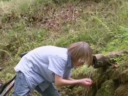 WS TD Boy drinking water with bicycle at forest / Tawern, Rhineland-Palatinate, Germany                             Stock Footage