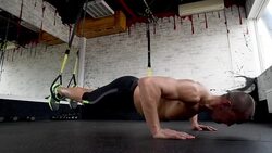beautiful athlete is pushed on trx straps Stock Footage