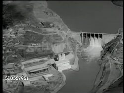 1951: CASABLANCA, MOROCCO: DAMS: AERIAL: Moving (R) over dam, hydroelectric plant in operation (Marshall Plan funds). Workers loifting gate on irrigation ditch. CU Water flowing. Instructional Video