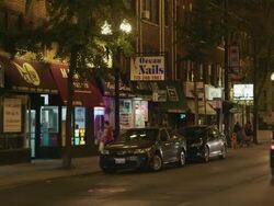 WS Street lined with shops night Stock Footage