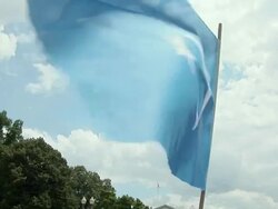 2009 MS TD Blue Uygur flag held by protestor shouting slogans in front of the White House during an anti-China protest in support of the Uygurs/ Washington D.C., USA/ AUDIO Stock Footage