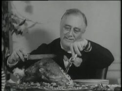 In 1941 U.S. President Franklin D. Roosevelt carves a turkey at a formal Thanksgiving dinner in Warm Springs, Georgia. Stock Footage