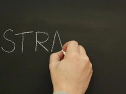 Someone writing 'Strategy' on school Blackboard Stock Footage