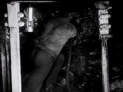 At the Coalface. British Movietone News Descends 700ft. Below Ground. News Clip
