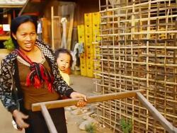 MS POV R/F SLO MO Shot of travelling woman pulling small wooden cart with his child / Mountain village near Muang Ngoi, Luang Prabang, Laos Stock Footage