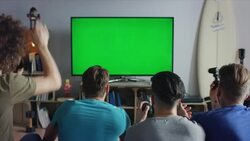 Guys sitting on couch playing video games Stock Footage